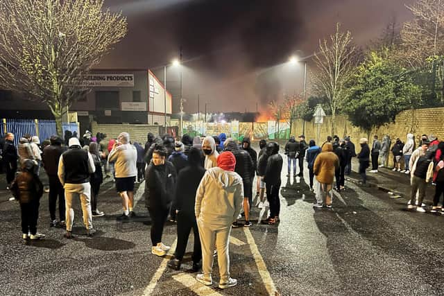 People gather by the the Peace Gates in Lanark Way, Belfast, during further unrest in Belfast.