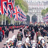 The State Gun Carriage carries the coffin of Queen Elizabeth II, draped in the Royal Standard with the Imperial State Crown and the Sovereign's orb and sceptre, in the Ceremonial Procession following her State Funeral at Westminster Abbey, London. Picture date: Monday September 19, 2022.