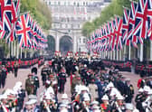 The State Gun Carriage carries the coffin of Queen Elizabeth II, draped in the Royal Standard with the Imperial State Crown and the Sovereign's orb and sceptre, in the Ceremonial Procession following her State Funeral at Westminster Abbey, London. Picture date: Monday September 19, 2022.