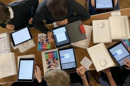 Pupils using iPads at school.