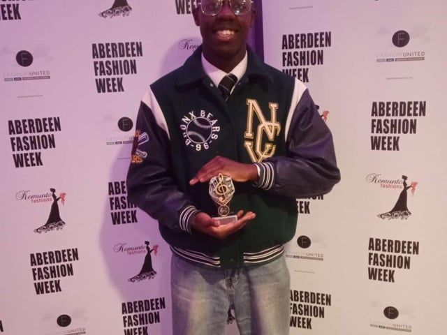Joel Baraza and his award for Outstanding Artistic Contribution.