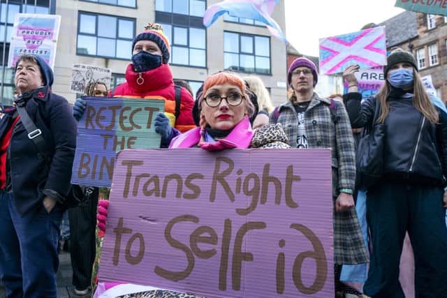 People take part in a demonstration for trans rights outside the UK Government Office at Queen Elizabeth House in Edinburgh. Th