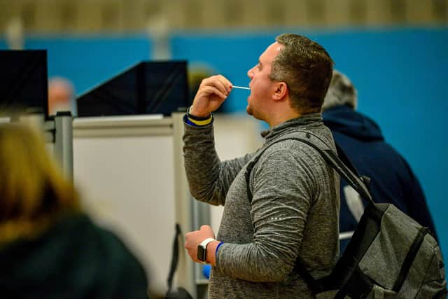 Members of the public complete a test swab during a lateral flow Covid test. Picture: PA Media