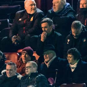 Motherwell manager Graham Alexander watches on from the stand.