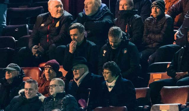 Motherwell manager Graham Alexander watches on from the stand.