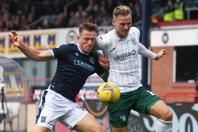 Hibs debutant James Scott battles for the ball with Dundee defender Lee Ashcroft
