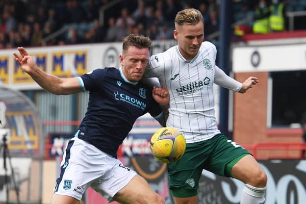 Hibs debutant James Scott battles for the ball with Dundee defender Lee Ashcroft