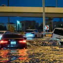 Cars drive in a flooded street following heavy rains in Dubai. Picture: Guiseppe Cacace/AFP via Getty Images