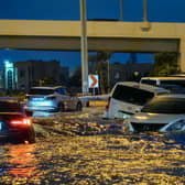 Cars drive in a flooded street following heavy rains in Dubai. Picture: Guiseppe Cacace/AFP via Getty Images