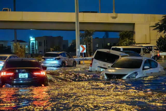 Cars drive in a flooded street following heavy rains in Dubai. Picture: Guiseppe Cacace/AFP via Getty Images