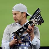 Andrew Friedman, the Los Angeles Dodgers president, holds the Warren C. Giles Trophy following his team's victory against the Atlanta Braves in the National League Championship Series.