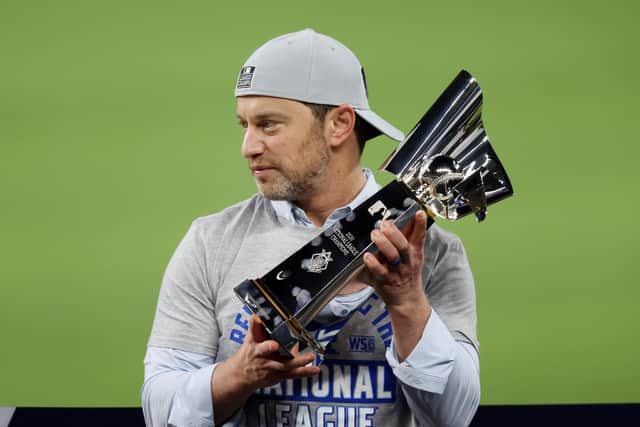 Andrew Friedman, the Los Angeles Dodgers president, holds the Warren C. Giles Trophy following his team's victory against the Atlanta Braves in the National League Championship Series.