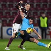 Dundee's Danny Mullen is tackled by Hearts' Peter Haring at Tynecastle on Wednesday. (Photo by Paul Devlin / SNS Group)