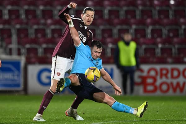 Dundee's Danny Mullen is tackled by Hearts' Peter Haring at Tynecastle on Wednesday. (Photo by Paul Devlin / SNS Group)