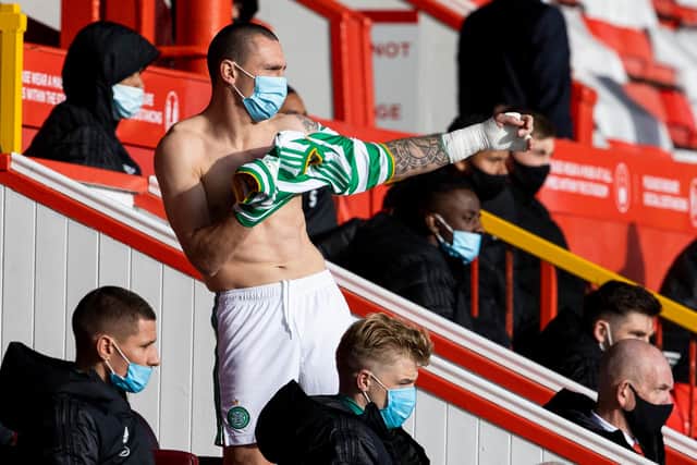 Scott Brown preparing to come off the bench in Celtic's 3-3- draw with Aberdeen last weekend. Picture: SNS
