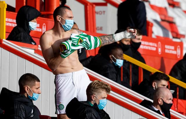 Scott Brown preparing to come off the bench in Celtic's 3-3- draw with Aberdeen last weekend. Picture: SNS