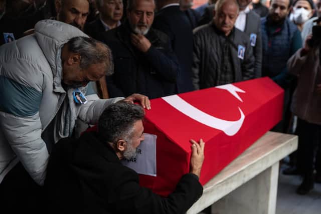Nurettin Ucar, father of 15-year-old victim Yagmur Ucar of Sunday's blast that took place on Istanbul's famous Istiklal Street, grieves during a funeral ceremony of his wife and daughter. Picture: Burak Kara/Getty Images
