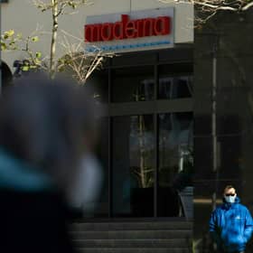 Pedestrians wearing face masks walk past the headquarters of biotechnology company Moderna in Cambridge, Massachusetts. Picture: Matthew Healey/AFP via Getty Images