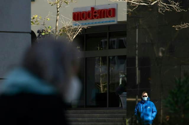 Pedestrians wearing face masks walk past the headquarters of biotechnology company Moderna in Cambridge, Massachusetts. Picture: Matthew Healey/AFP via Getty Images