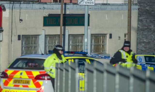 Police Scotland is investigating reports of a man being shot dead outside an Edinburgh pub, which shut down several streets in the capital on New Years Eve.