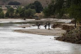Officers of the Guardia Civil search through a river in the town of Aldea del Fresno, in the Madrid region on Monday, as a man was reported missing after his vehicle was swept away by an overflowing river during heavy rains.