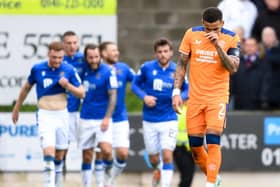 Rangers captain James Tavernier hangs his head as St Johnstone players celebrate going 1-0 up. (Photo by Ross MacDonald / SNS Group)