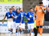 Rangers captain James Tavernier hangs his head as St Johnstone players celebrate going 1-0 up. (Photo by Ross MacDonald / SNS Group)