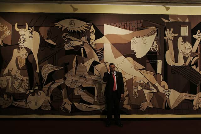 A reproduction of Pablo Picasso's famous painting Guernica is displayed at the United Nations headquarters (Picture: Chris Hondros/Getty Images)