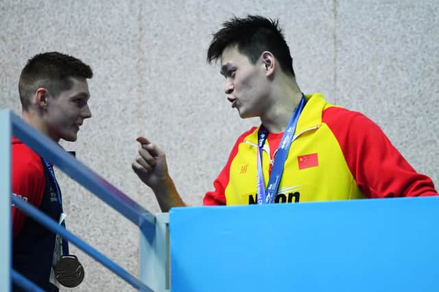 Duncan Scott and Sun Yang exchange words on the podium during the medal ceremony for the 200m freestyle final at the 2019 World Championships in Gwangju, South Korea. Picture: Quinn Rooney/Getty Images