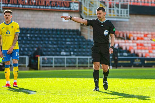 Referee Nick Walsh awards a penalty to Dundee United.