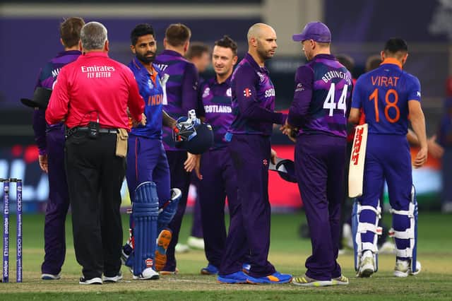 Players of Scotland and India shake hands after the defeat in Dubai.