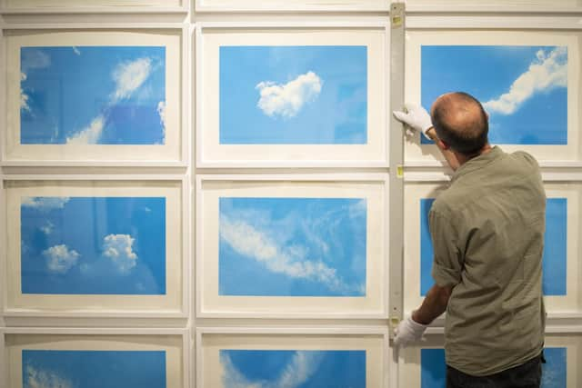 A technician installing Always Take the Weather With You, 2014, by Rohini Devasher at the Love of Print show at Kelvingrove PIC: Ross MacDonald - SNS Group