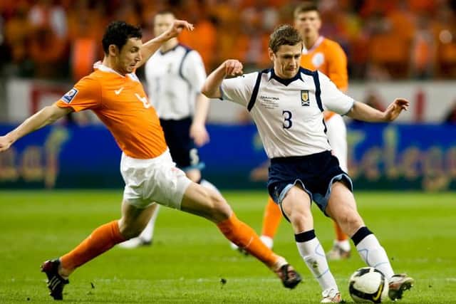 Gary Naysmith in action for Scotland against Mark van Bommel of Netherlands during a World Cup qualifier in Amsterdam in March 2009. (Photo by Alan Harvey/SNS Group).