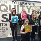 Children from Lornshill Academy show what actions can be taken to reach Net Zero by 2045.