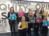 Children from Lornshill Academy show what actions can be taken to reach Net Zero by 2045.