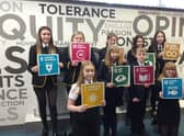 Children from Lornshill Academy show what actions can be taken to reach Net Zero by 2045.