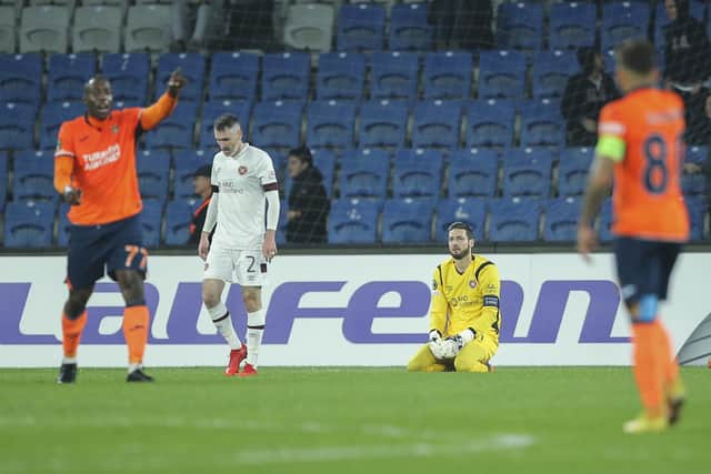 Hearts' goalkeeper Craig Gordon sits on the ground after his mistake led to Basaksehir's Serdar Gurler scoring his side's second goal. (AP Photo)