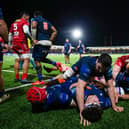 Edinburgh's Marshall Sykes lies on top of a pile of bodies during the win over Scarlets.