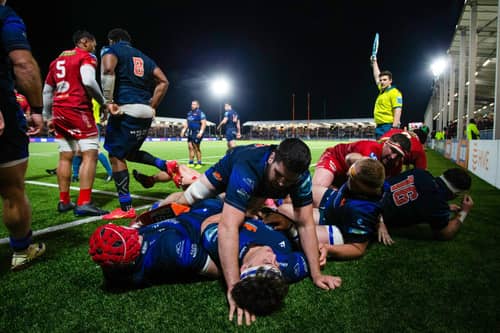 Edinburgh's Marshall Sykes lies on top of a pile of bodies during the win over Scarlets.