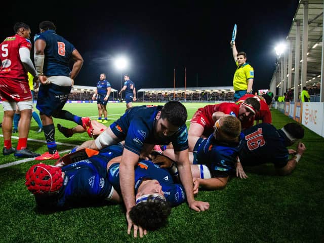 Edinburgh's Marshall Sykes lies on top of a pile of bodies during the win over Scarlets.