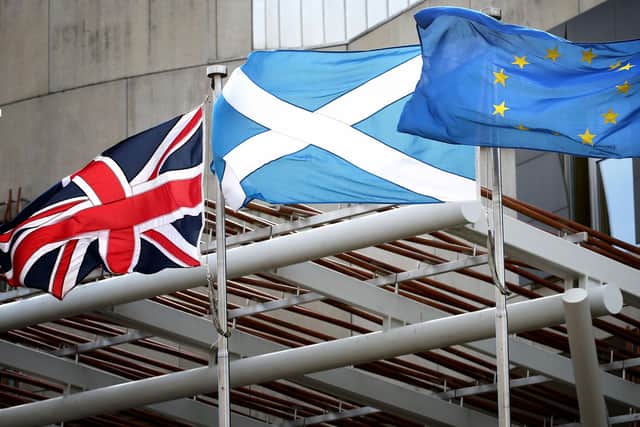A Union Jack, Saltire and European flag fly outside the Scottish Parliament in Edinburgh. Picture: PA