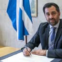 Humza Yousaf signs his official letter of resignation as First Minister to King Charles at the Scottish Parliament (Picture: Jane Barlow/pool/Getty Images)