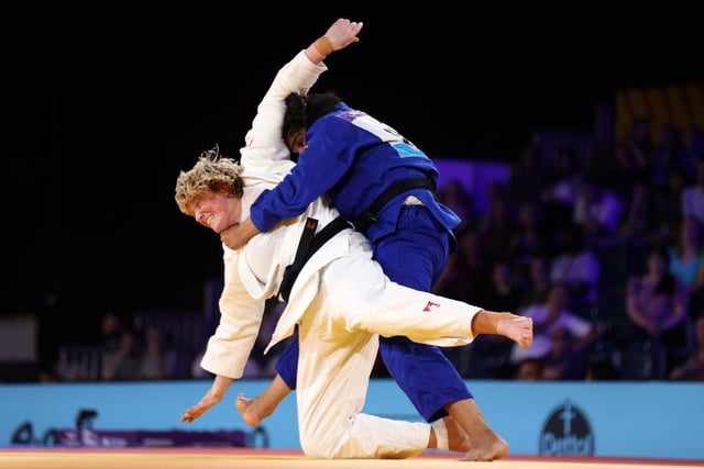 Sarah Adlington on her way to victory over Tulika Maan of Team India during the Women's Judo +78 kg Final match.