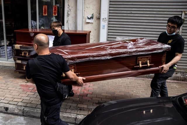 An empty coffin is moved to a hearse in the Kowloon district of Hong Kong.