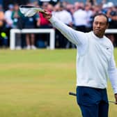 Tiger Woods acknowledges the crowd as he crosses the Swilcan Bridge at the Old Course, St Andrews. (Photo by Ross Parker / SNS Group)