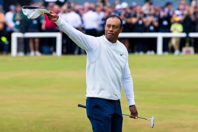 Tiger Woods acknowledges the crowd as he crosses the Swilcan Bridge at the Old Course, St Andrews. (Photo by Ross Parker / SNS Group)