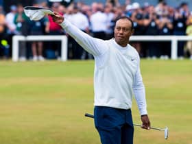 Tiger Woods acknowledges the crowd as he crosses the Swilcan Bridge at the Old Course, St Andrews. (Photo by Ross Parker / SNS Group)