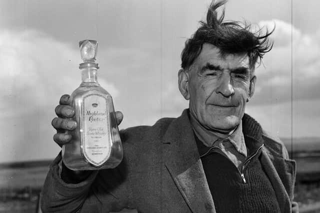 South Uist man John Morrison with an empty bottle of Highland Nectar whisky he liberated from the SS Politician  when she went aground in 1941.