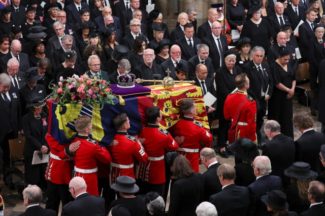 The coffin of Queen Elizabeth II with the Imperial State Crown resting on top carried by the Bearer Party into Westminster Abbey the State Funeral of Queen Elizabeth II, held at Westminster Abbey, London. Picture date: Monday September 19, 2022.