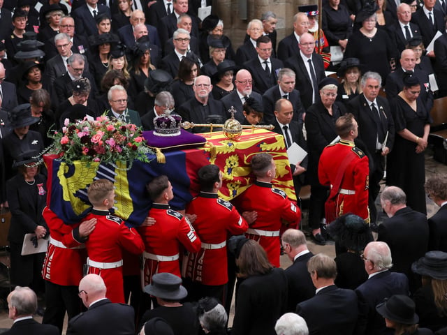 The coffin of Queen Elizabeth II with the Imperial State Crown resting on top carried by the Bearer Party into Westminster Abbey the State Funeral of Queen Elizabeth II, held at Westminster Abbey, London. Picture date: Monday September 19, 2022.